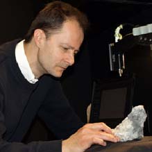 Benoit Rivard examines a mineral using spectroscopy